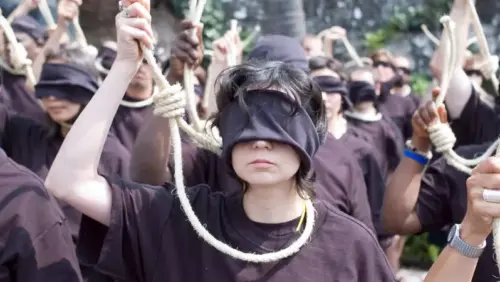 Jugendliche in Mexiko bei einer Demonstration gegen die Hinrichtung von Minderjährigen im Iran. Die Demonstrierenden haben die Augen verbunden und halten symbolisch eine Henkerschlinge um den Hals in der Hand